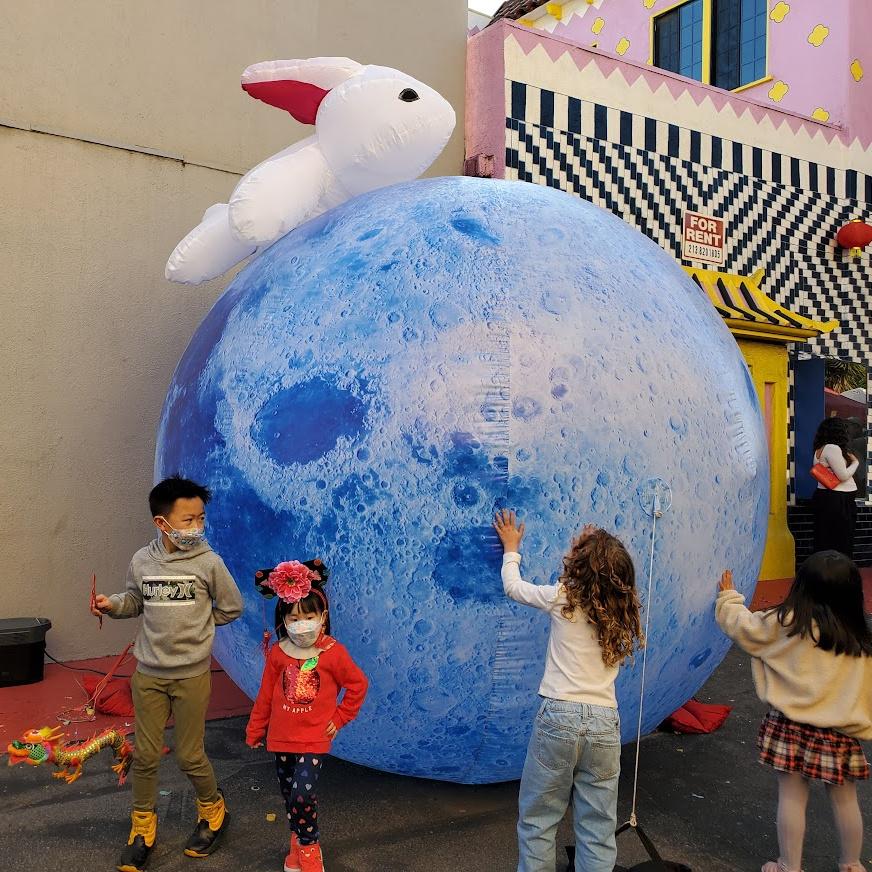 Kids playing with a Year of the Rabbit balloon