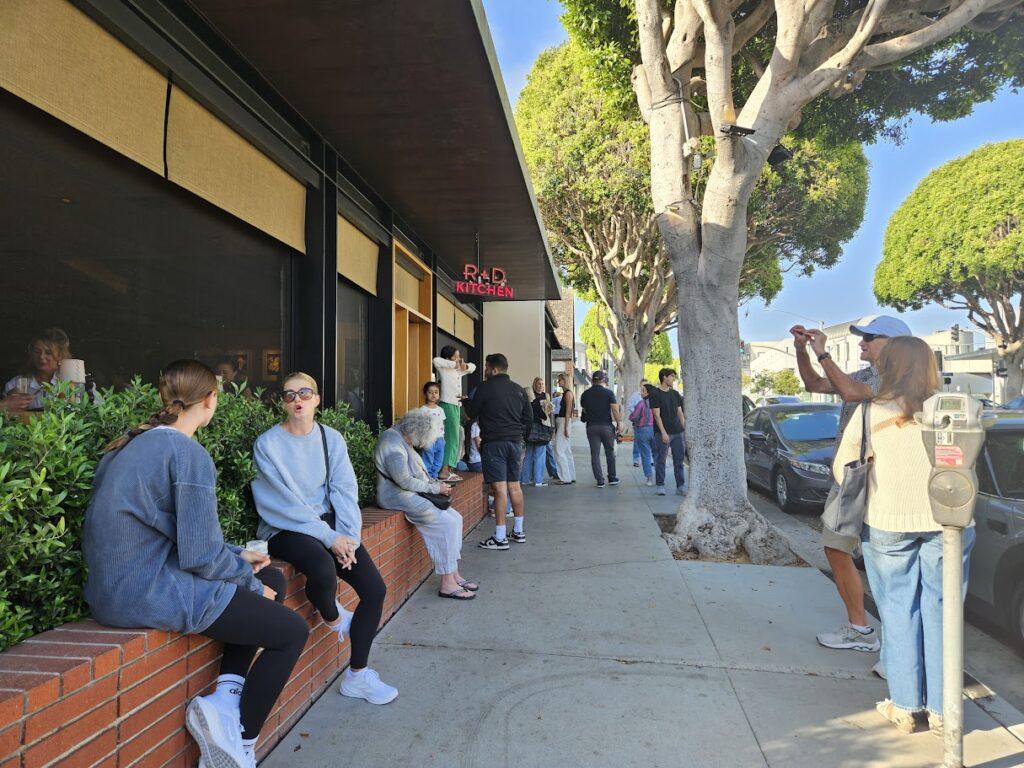 People waiting to go the a restaurant on Montana Avenue.