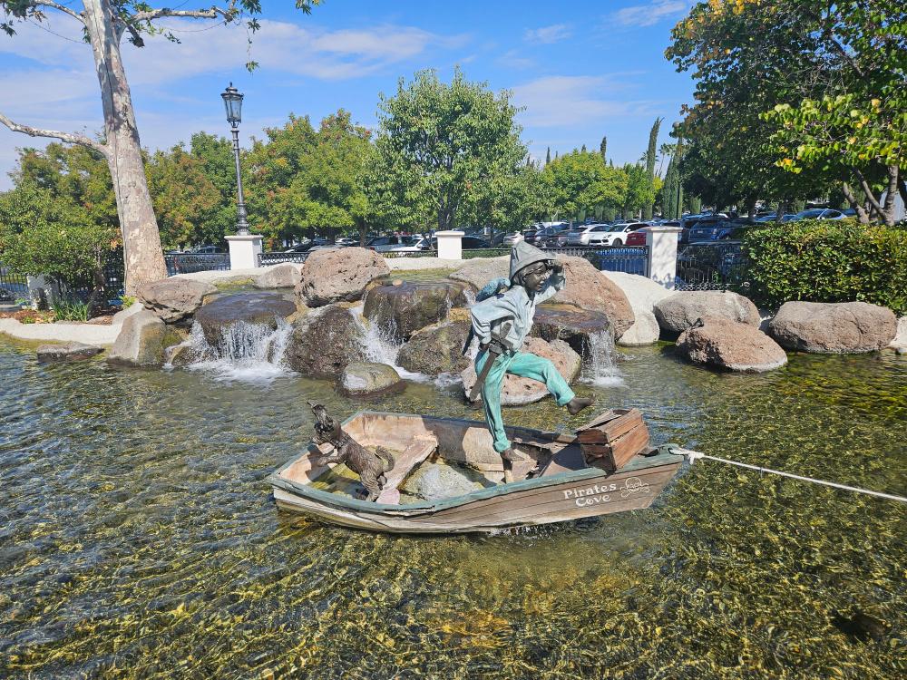 Statue of a boy in a boat with a dog at The Commons in Old Calabasas.